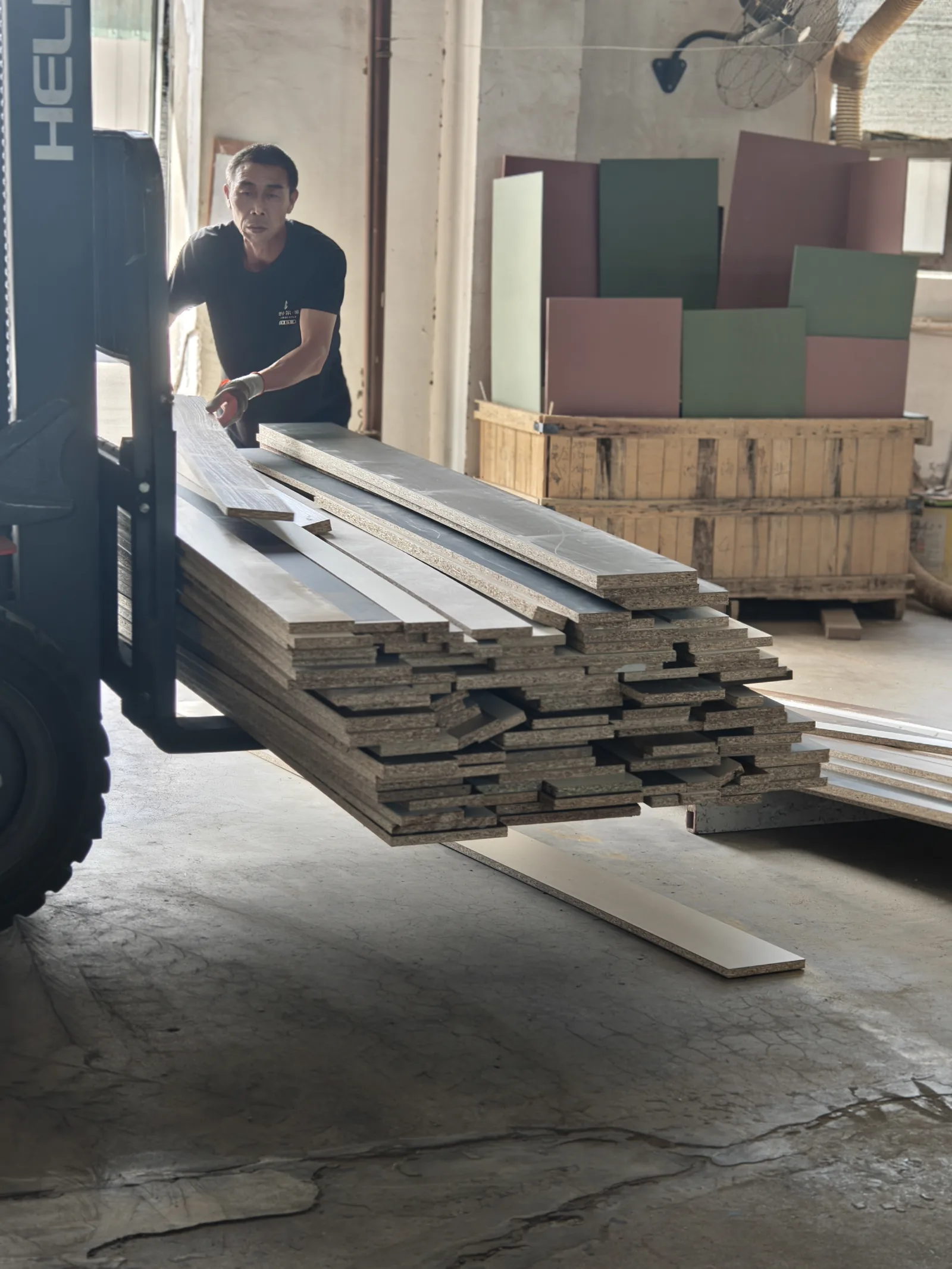 SNEJ operator moving timber panels with a forklift in the Xinmin factory