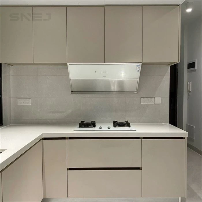 Taupe kitchen cabinets with a white extractor hood - Home Custom Cabinets by SNEJ