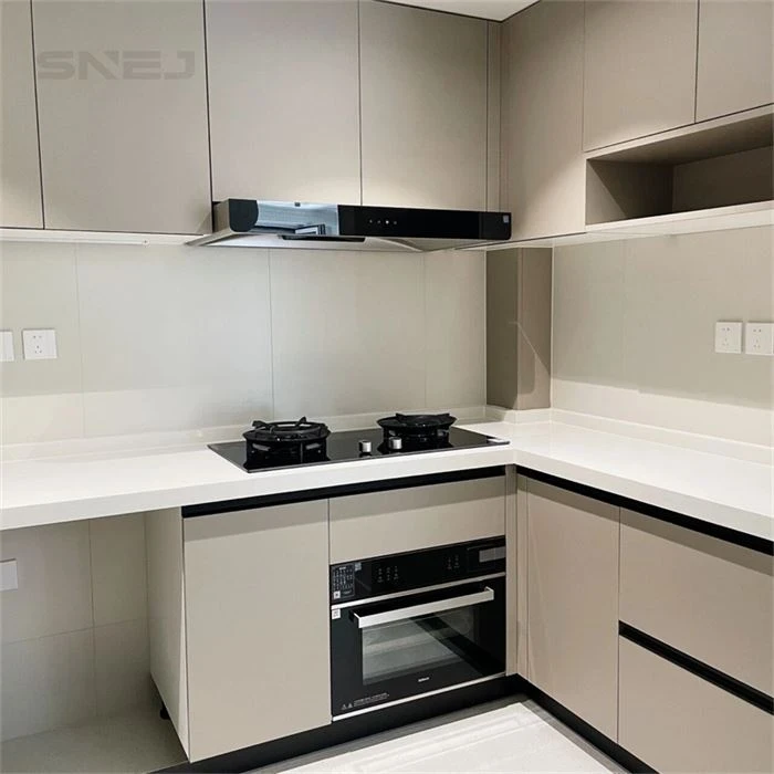 Pale kitchen cabinets with a built-in oven and corner worktop - High Gloss Modern Cabinets by SNEJ