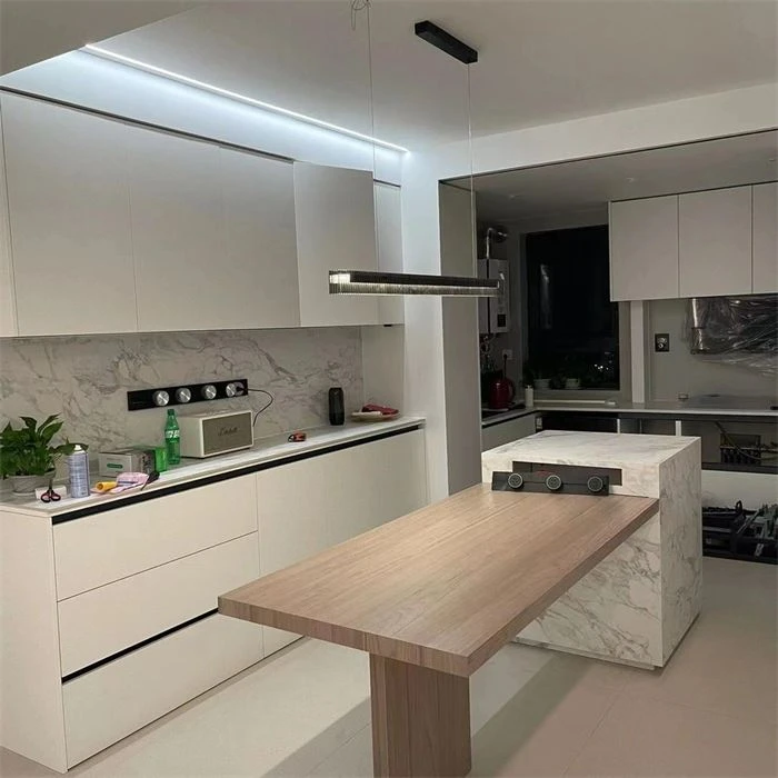Kitchen cabinets surrounding a wood-tone breakfast counter - Semi Custom Inset Cabinets by SNEJ