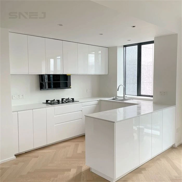 White kitchen cabinets with a peninsula and wood-tone floor - Modern Gloss Cabinets by SNEJ