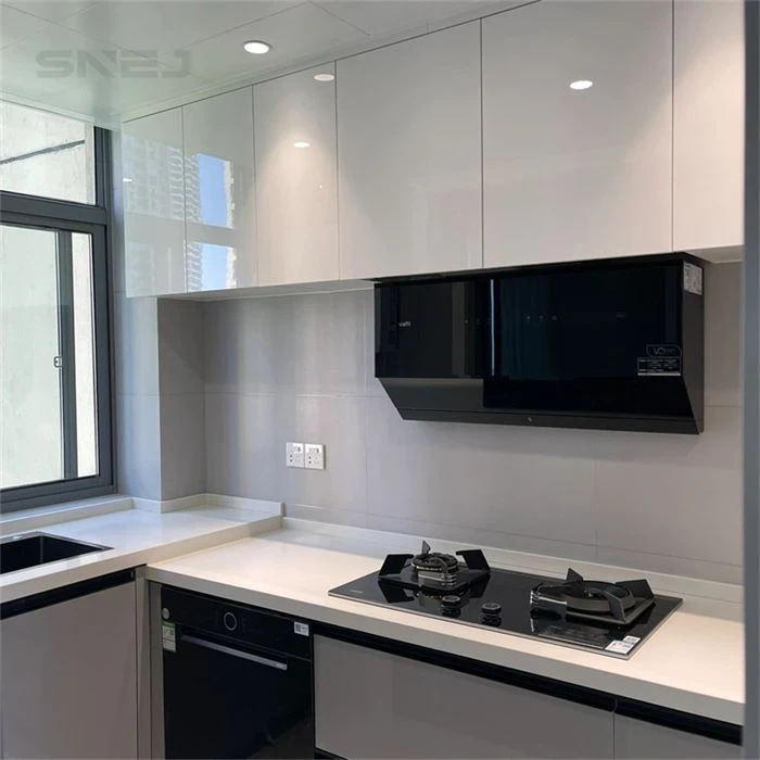 White kitchen wall cupboards above a compact cooking area - Modern Kitchen Cabinets For Small Spaces by SNEJ