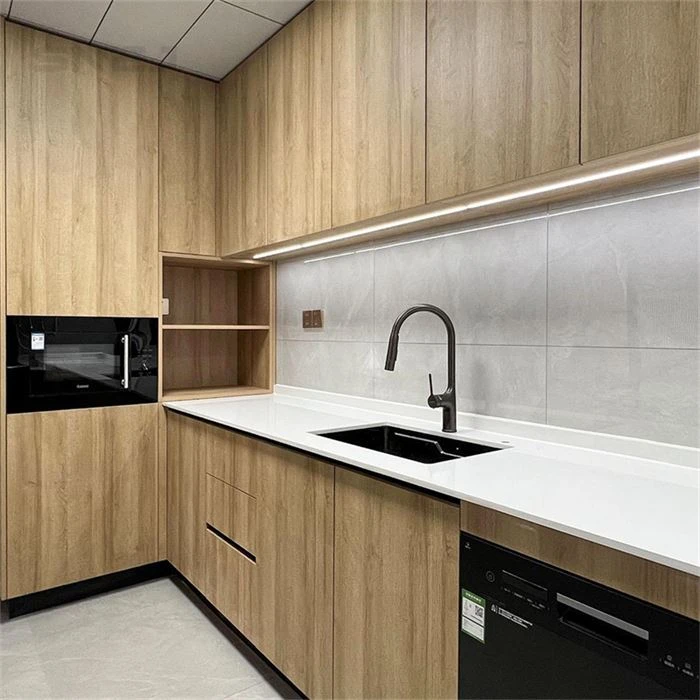 Wood-grain kitchen cabinets with a black sink and white worktop - American Custom Cabinets by SNEJ