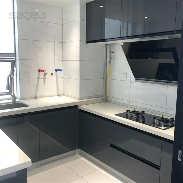 Dark grey kitchen cabinets around a corner cooking area - Kitchen Cabinets Bespoke by SNEJ