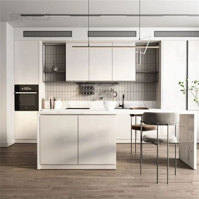 Pale kitchen island with seating and tall appliance cabinets - Custom Melamine Cabinets by SNEJ