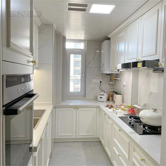 White framed kitchen cabinets in a narrow cooking space - Custom Shaker Kitchen Cabinets by SNEJ