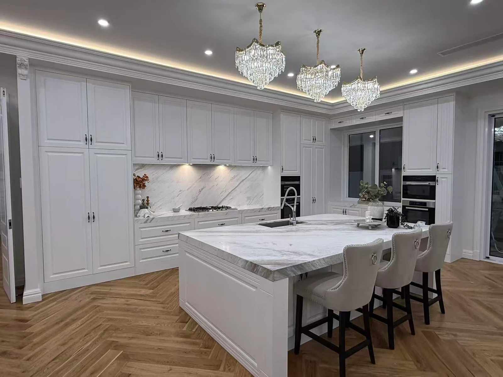 Painted kitchen cabinetry with framed fronts and an island