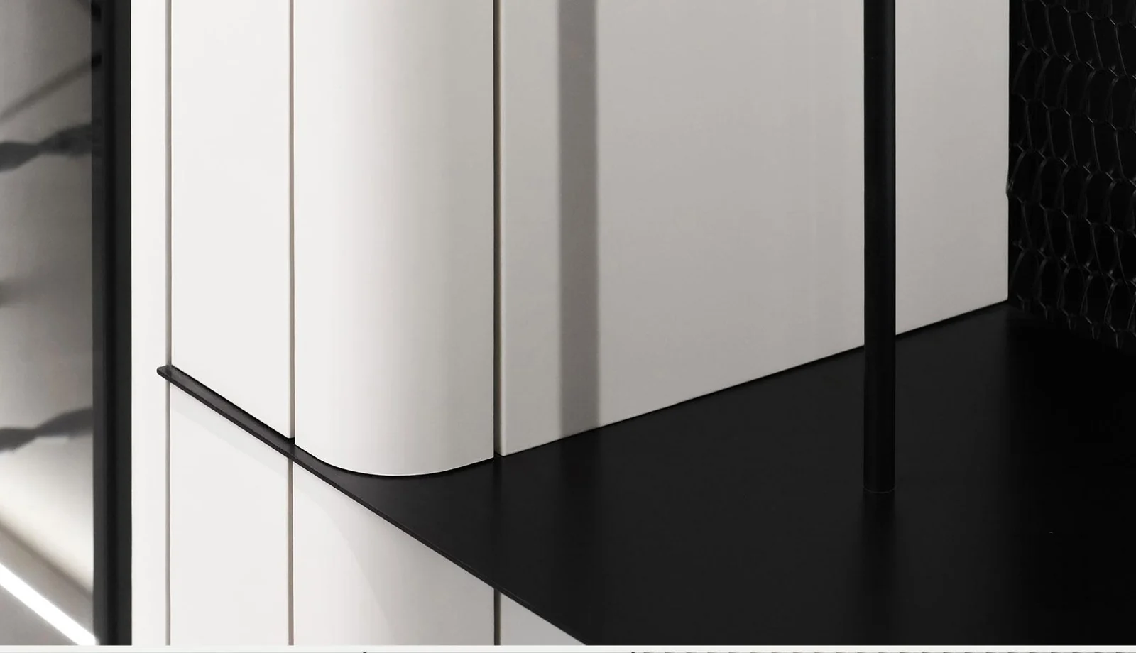 Rounded pale cabinet corner above a contrasting dark horizontal band