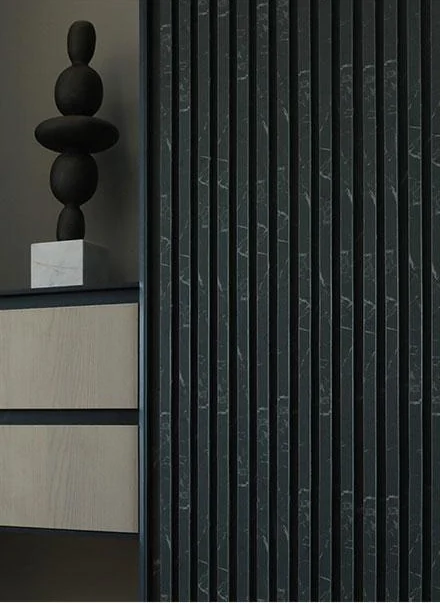 Recessed dark cabinet pulls beside drawers and a vertically fluted panel