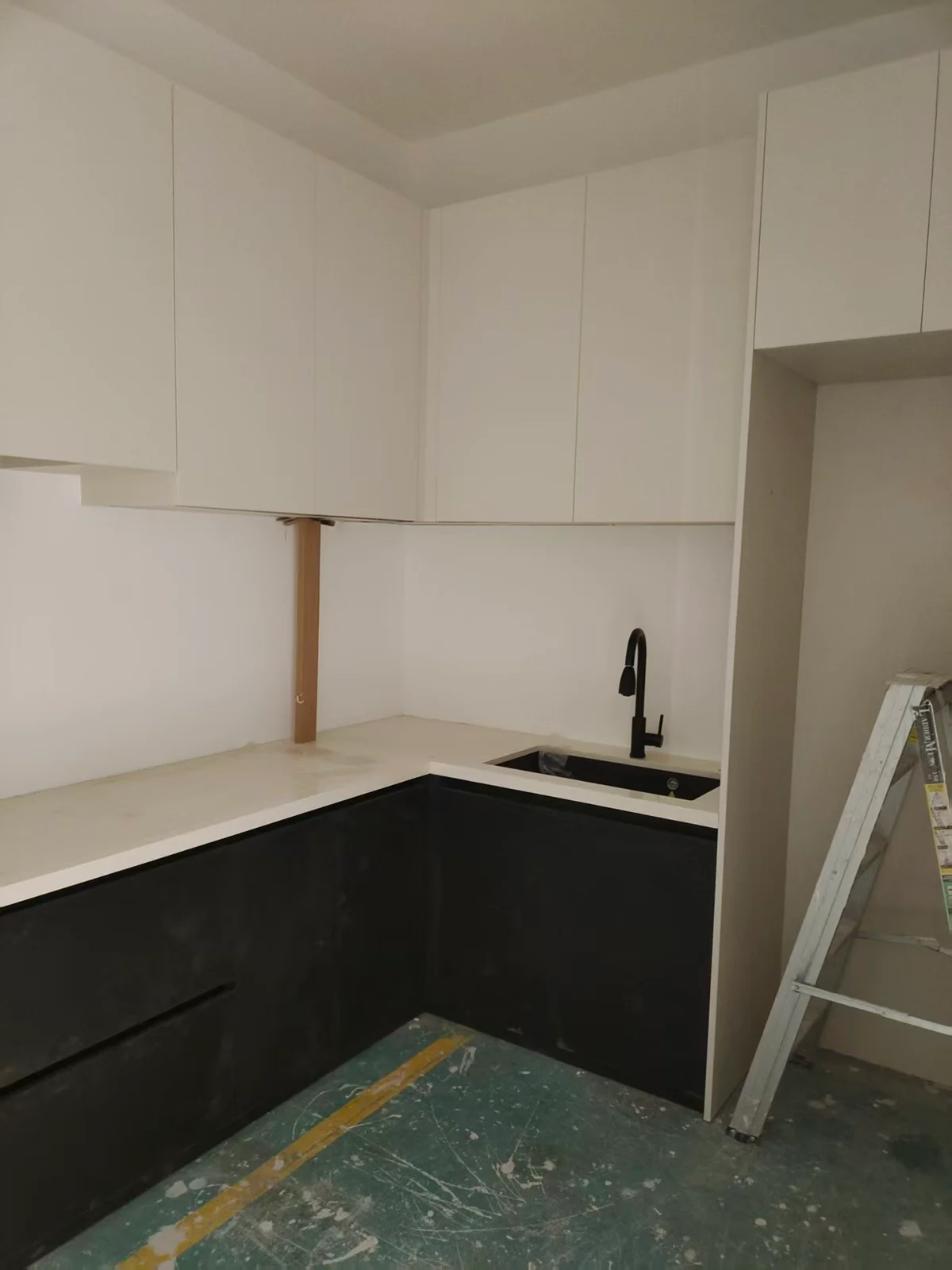 L-shaped kitchen cabinetry during installation